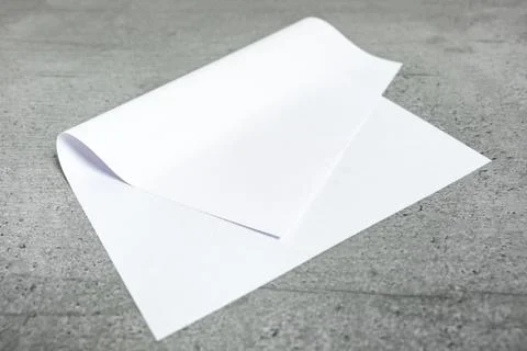 Blank paper sheet on grey background.  Stock Photos