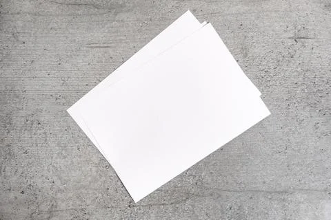 Blank paper sheets on grey background. Stock Photos