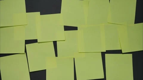 Blank paper sticky notes appear on black background. Stop motion animation Stock Footage 314342615