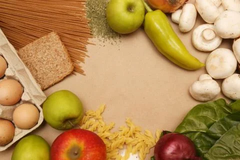 Blank paper surrounded by basic food ingredients. Add own text. Stock Photos