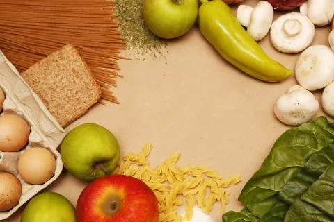 Blank paper surrounded by basic food ingredients. Add own text. Stock Photos