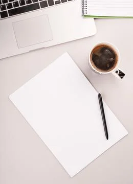 Blank paper on the working desk with computer and coffee Stock Photos
