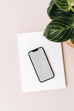 Blank path screen mobile phone with mockup on various notepads on beige bac.. Stock Photos
