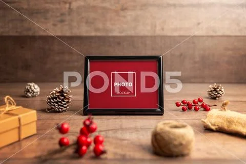 Blank photo frame in rustic Christmas arrangement PSD Template
