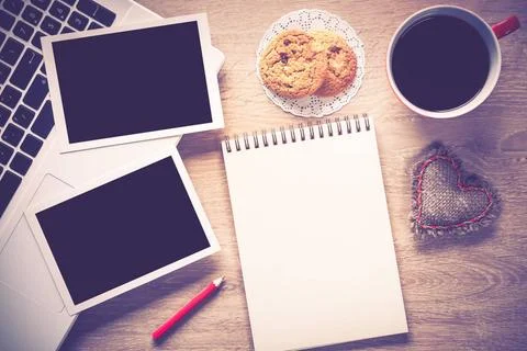 Blank photo frames on table Laptop with coffee cup photos and pen on woode... Stock Photos