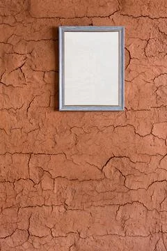 Blank picture frames on soil wall of earth shelter, also called an earth hous Stock Photos