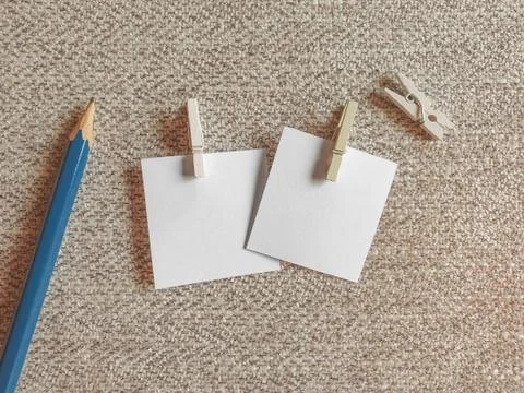 A Blank Pieces of Note Papers and Wood Clothespins on the Cloth Stock Photos
