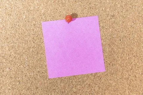 Blank pink note and push pin on cork board. Template to ad text or drawings Stock Photos