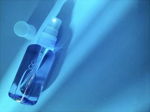 Blank plastic bottle with sprayer cap on blue Stock Photos
