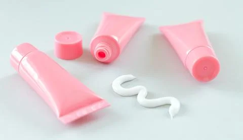 Blank plastic tubes with squeezed out beauty or medical cream Stock Photos