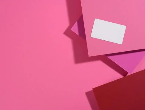 Blank rectangular business card lies on a modern pink background sheets of pa Stock Photos