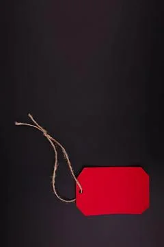Blank red tag with string on dark background Stock Photos