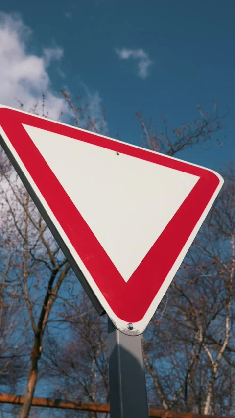 Blank Red Triangle Warning Sign from Low Angle Against Blue Sky Видео 334105413
