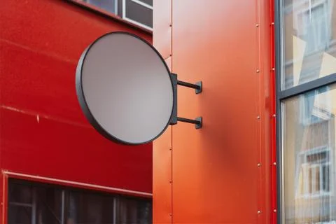 Blank round store signboard. Empty shop lightbox on the red wall. 3d rendering. Ilustração Stock