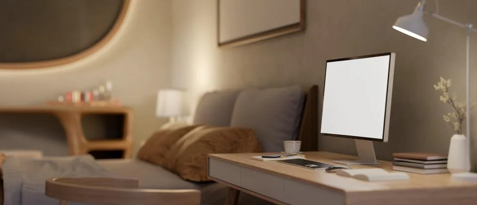 Blank screen computer with books and coffee and lamp aside on wooden table .. 스톡 일러스트