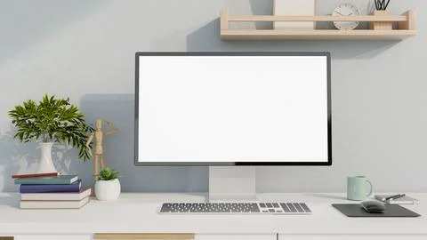 Blank screen computer with books and decors on white table, study corner in.. Stock Photos