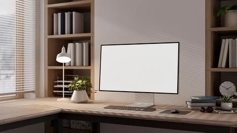 Blank screen computer with a lamp and books on wooden table in a room with .. Stock Illustration