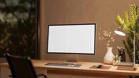 Blank screen computer with lamp and flower vase on wooden drawer table and .. 스톡 일러스트