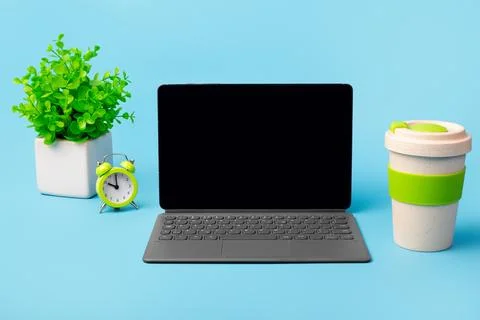 Blank screen computer tablet with keyboard case, desktop with coffee cup, pot Stock Photos