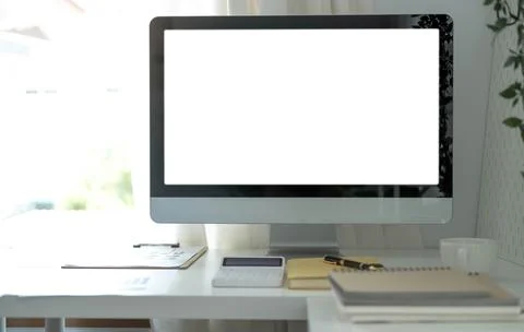 Blank screen desktop computer in minimal office room with decorations and c.. Stock Photos