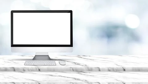 Blank screen of desktop computer on step white marble table with blur hospita 스톡 사진