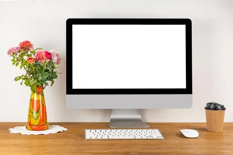 Blank screen desktop computer with wireless keyboard and mouse on wooden tabl Stock Photos