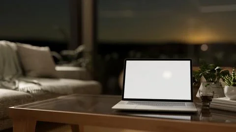 Blank screen laptop aside coffee cup and plants on glass top wooden table i.. Illustrazione stock
