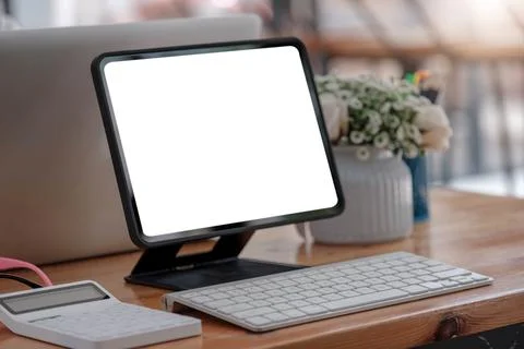 Blank screen Laptop computer and poster workspace background in modern office Stock Photos