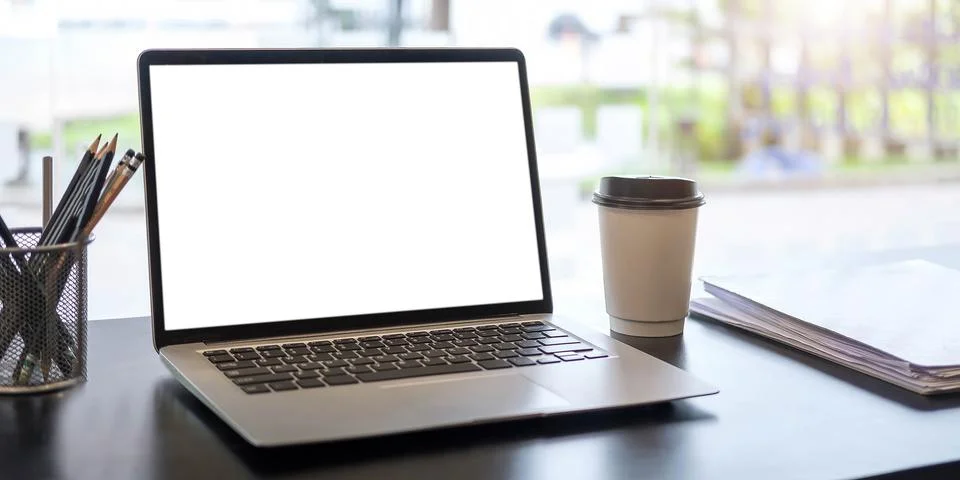 Blank screen Laptop computer and poster workspace background in modern office Stock Photos