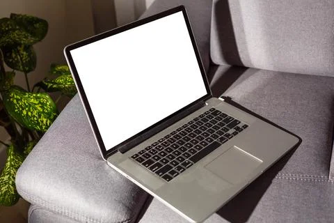 Blank screen laptop computer on sofa Stock Photos