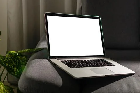 Blank screen laptop computer on sofa Stock Photos