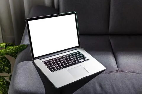 Blank screen laptop computer on sofa Stock Photos
