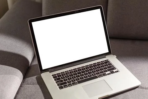 Blank screen laptop computer on sofa Stock Photos