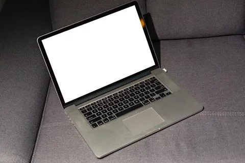 Blank screen laptop computer on sofa Stock Photos