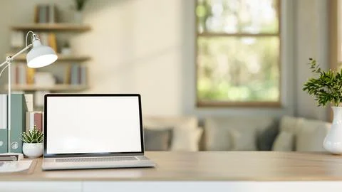Blank screen laptop with file folder and cactus aside lamp on wooden table .. 스톡 일러스트
