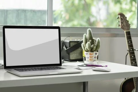 Blank screen laptop on working desk with clipping path Stock Photos