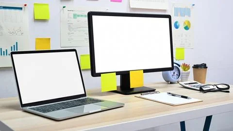 Blank screen mockup computer and laptop with office equipment on the desk i.. Fotos Stock