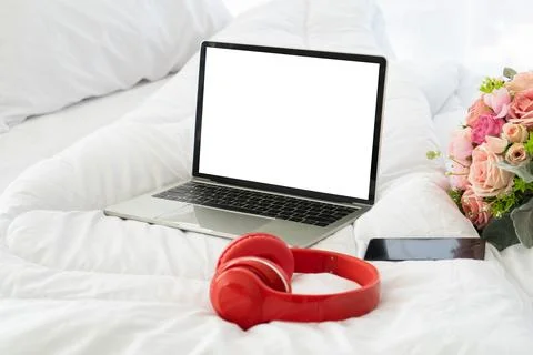 Blank screen notebook computer and smartphone on bed,Holiday concept Fotos Stock