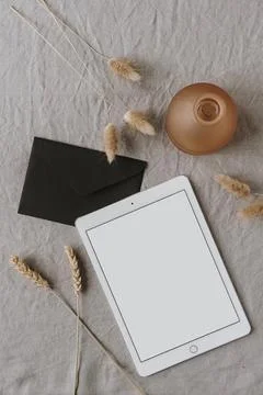 Blank screen tablet, envelope, decorations, ear / wheat ear stalks on grey wa Stock Photos