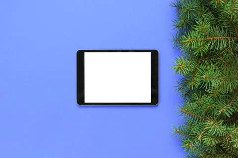 Blank screen tablet on purple background, christmas time top view Stock Photos