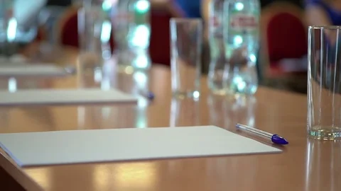 A blank sheet of A4 paper on the table with a pen. A business audience (school Stock Footage 76243040