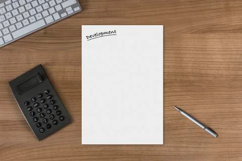 Blank sheet Development on a wooden table with calculator Stock Photos