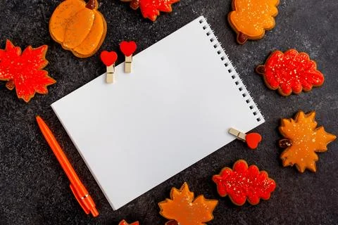 Blank sheet for notes orange pen and leaf-shaped cookies. top view horizontal Stock Photos