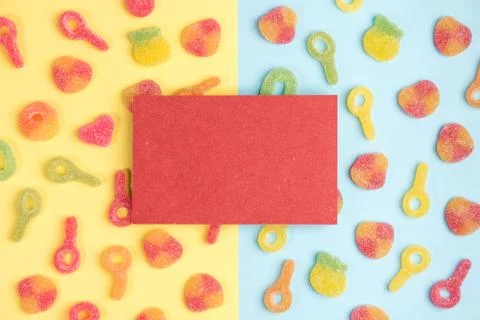 Blank sheet of paper on background of gummy candies. Multicolored candies on  Stock Photos