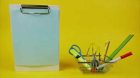 Blank sheet of paper with place for text and stationery next to it. Stop motion Stock-Footage 143871845