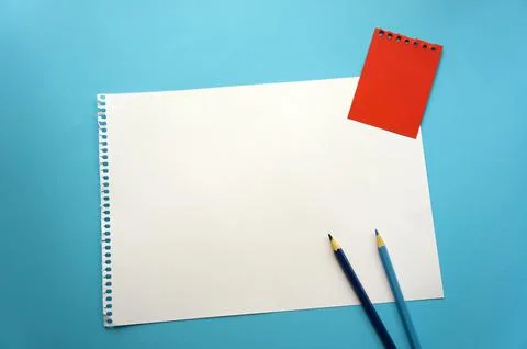 Blank sheet of paper space for design and lettering on a beautiful blue backg Stock Photos