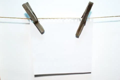 Blank sheet paper on wooden clothespin Stock Photos