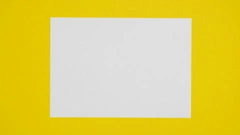 Blank sheet of white paper appears on yellow background  from a paper ball. Stock Footage 239639025