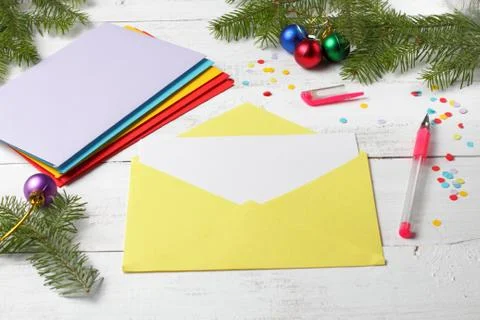 A blank sheet for writing, a stack of multi-colored envelopes with congratula Foto stock