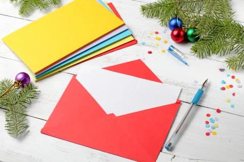 A blank sheet for writing, a stack of multi-colored envelopes with congratula Foto stock